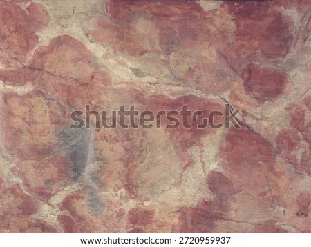 Ochre pigment creating abstract patterns and textures on an ancient rock surface