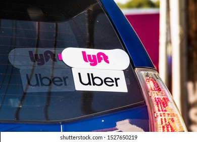 Oct 10, 2019 Mountain View / CA / USA - Lyft and UBER stickers on the rear window of a vehicle offering rides in San Francisco Bay Area