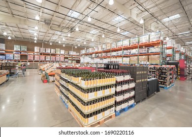 OCT 19, 2018-LEWISVILLE, TX, US: Tasting Table Near Wide Selection Of Wine And Champagne Display In Wooden Wine Boxes At Aisle Stacks In Costco Wholesale Store. Variety Of Beverage With Price Tags