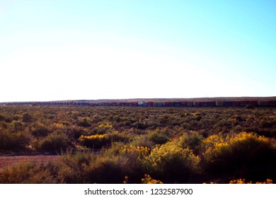 Oct 4th 2018. Holbrook Arizona. Landscape Of Holbrook Featuring The Santa Fe Freight Train. The Train Cuts Through The Petrified Forest National Park Causing Noise Pollution In A Protected Area.