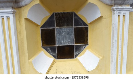 Octagonal Window On A Yellow Wall