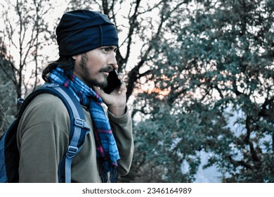 October 14th 2022 Uttarakhand, India. Young traveler on phone during winter trip in Mussoorie hillstation, Uttarakhand, India