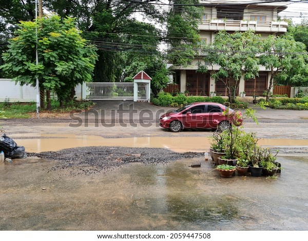 October 18,2021 Ratchaburi, Thailand Community\
roads that are lower than the buildings on both sides of the road.\
The road became a pool of water.\
