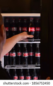 October 19, 2020 - Thornhill, Ontario Canada: Man Is Reaching Into A Refrigerator In A Restaurant To Grab A Bottle Of Coca Cola