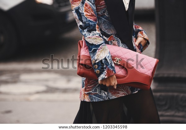 October 2, 2018: Paris, France - Fashionable girl\
wearing a Chanel bag outside a fashion show during Paris Fashion\
Week  - PFWSS19