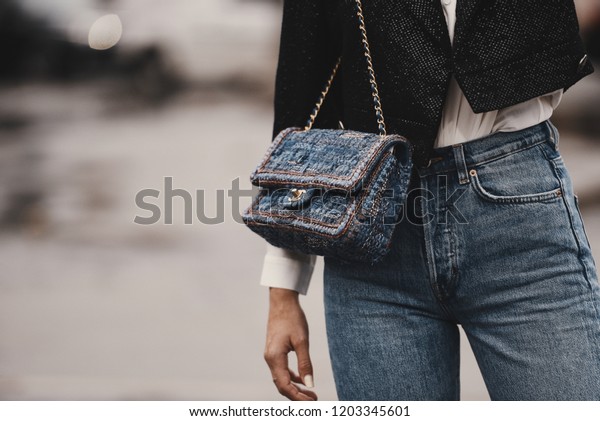 October 2, 2018: Paris, France - Fashionable girl\
wearing a Chanel bag outside a fashion show during Paris Fashion\
Week  - PFWSS19