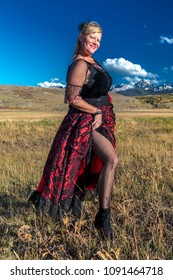 OCTOBER 2017, Ridgway, Colorado: Amanda Wears Red Saloon Girl Western Costume On Historic Last Dollar Ranch, Hastings Mesa