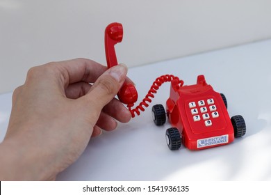 October 2019, Swansea, UK. Direct Line Car Insurance Company.
Rotary Dial Style Miniature Red Landline Phone On Wheels.