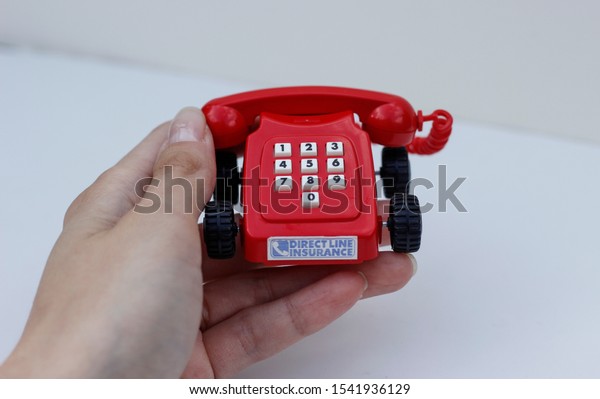 October\
2019, Swansea, UK. Direct Line Car Insurance Company.\
Rotary Dial\
Style miniature red landline phone on\
wheels.