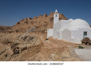 October 2019-View of a white Mosque at Chenini deserted hilltop old berbere town in tunisia against blue sky. A ruined Berber village in the Tataouine district in southern Tunisia. 