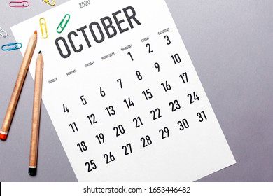 October 2020 simple calendar with office supplies and copy space