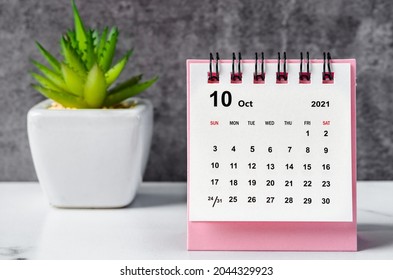 October 2021 desk calendar on wooden table. - Shutterstock ID 2044329923
