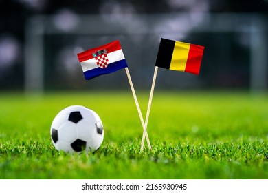 October 2022: Croatia Vs. Belgium, Ahmad Bin Ali, Football Match Wallpaper, Handmade National Flags And Soccer Ball On Green Grass. Football Stadium In Background. Black Edit Space.