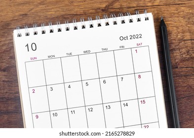 The October 2022 desk calendar on wooden table. - Shutterstock ID 2165278829