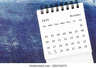 October 2022 Monthly Desk Calendar For 2022 Year On Old Blue Wooden Background.