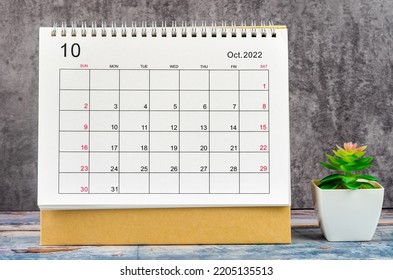 October 2022 Monthly Desk Calendar For 2022 Year On Wooden Table.