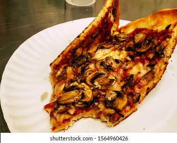 October 26th 2019 Providence Rhode Island USA Antonio's Pizza By The Slice. New York Thin Crust Pizza With Mushrooms On A White Paper Plate With A Few Bites Taken Out Of It.