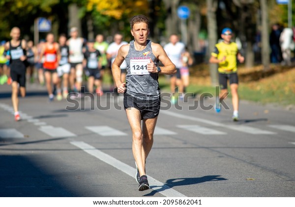October 3, 2021 Bila Tserkva, Ukraine\
Marathon race, leader athlete runner running city marathon. Running\
people at Marathon\
competition