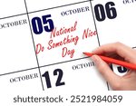 October 5. Hand writing text National Do Something Nice Day on calendar date. Save the date. Holiday.  Important date. Day of the year concept.