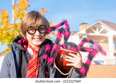 October 8, 2022. Moscow, Russia. Little Happy Boy In Harry Potter Costume With Magic Wand Sitting Outside