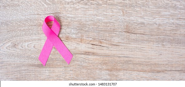 October Breast Cancer Awareness month, Pink Ribbon on wood background for supporting people living and illness. Healthcare, International Women day and World cancer day concept - Powered by Shutterstock