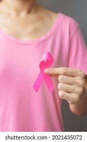 October Breast Cancer Awareness month, elderly Woman in pink T- shirt with hand holding Pink Ribbon for supporting people living and illness. International Women, Mother and World cancer day concept - Shutterstock ID 2021435072