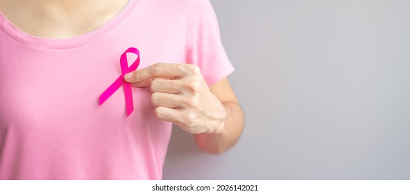 October Breast Cancer Awareness month, elderly Woman in pink T- shirt with hand holding Pink Ribbon for supporting people living and illness. International Women, Mother and World cancer day concept - Shutterstock ID 2026142021