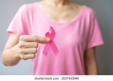 October Breast Cancer Awareness month, elderly Woman in pink T- shirt with hand holding Pink Ribbon for supporting people living and illness. International Women, Mother and World cancer day concept - Shutterstock ID 2037433040