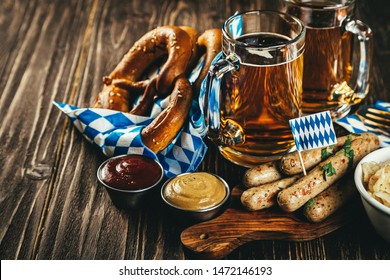 October fest concept - traditional food and beer served at event, wood background