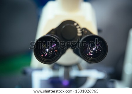 Ocular eyepiece lenses of binocular microscope, close up, selective focus