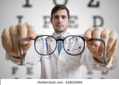 Oculist doctor is giving glasses to a patient. Eye sight testing concept.