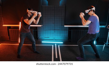 Oculus Rift VR glasses sport boxing game. People in vr technology headsets box simulation fight. Virtual reality game match. Gamer person in augmented goggles studio with neon light. AR gadgets set. - Powered by Shutterstock