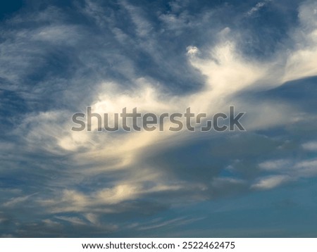 Odd evening cloud formation that by a stretch of imagination (pareidolia, a psychological phenomenon) might evoke a humanoid form reeling from a blow and falling backward across the sky