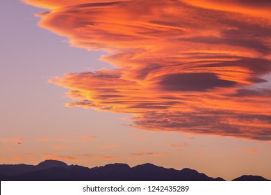 Odd Looking Gigantic Cloud Appear Over Southern Nevada Mountains At Sunset. Las Vegas, NV Area. Beautiful Purple, Orange, And Red Colors In The Twilight Sky. Plenty Of Negative Space For Text.