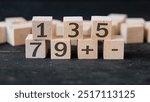 odd numbers word written on wooden block with blur background