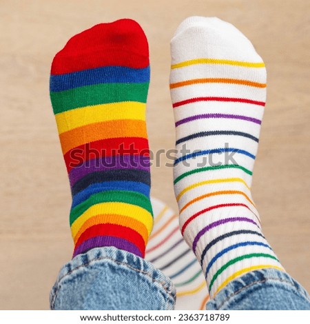 Odd socks day, anti-bullying week social concept. close-up of baby's feet in multi-colored mismatched socks