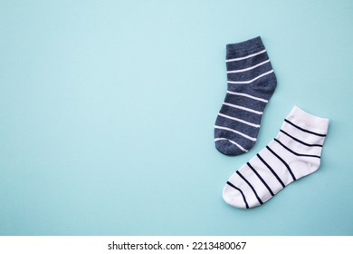 Odd Socks Day Concept. Mismatch Socks At Blue.