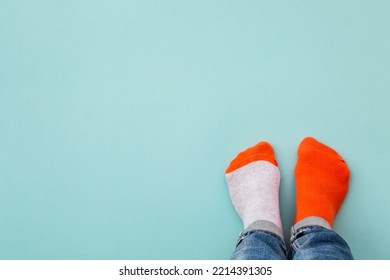 Odd socks day concept. Mismatch socks at blue.