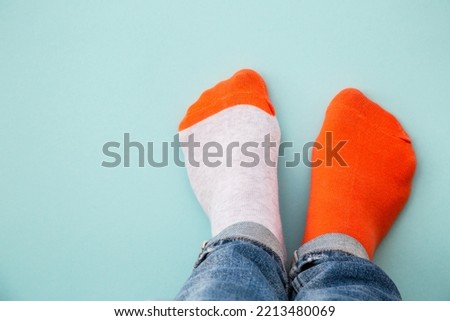 Odd socks day concept. Mismatch socks at blue.