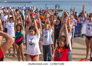 ODESSA, UKRAINE - 08.09.2018: OceanMan We open open water swimming competition for children. Swimmers children from shore get into water and big race in swimming on open water of Sea. Sports lifestyle