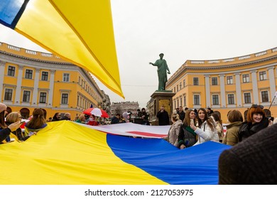 ODESSA, UKRAINE - 20 FEB 2022: Unity March In Odessa Against Russian Invasion. People With Blue And Yellow Flag On Potemkn Stairs. Statue Of Duk