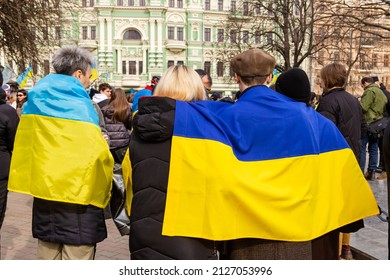 ODESSA, UKRAINE - 20 FEB 2022: Unity March In Odessa Against Russian Invasion. People Hugs And Cover With Ukrainian Flag, Concept Of Unity.