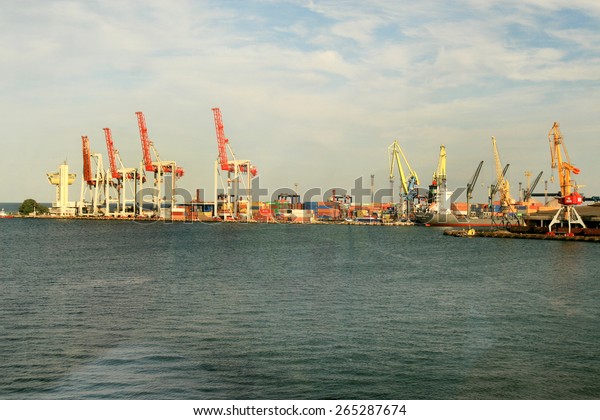 Odessa, Ukraine -5 December 2008: Sea container\
terminal. Marine cranes loads more shipping containers on cargo\
ship. The storage area containers. Sea transportation of cargo.\
Fashion Vanilla tinting