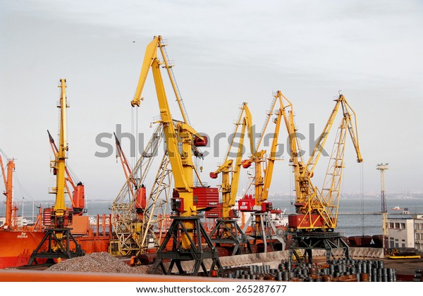 Odessa, Ukraine\
-5 December 2008: Sea container terminal. Marine cranes loads more\
shipping containers on a cargo ship. The storage area containers.\
Sea transportation of\
cargo