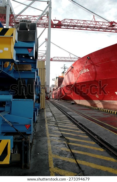 Odessa, Ukraine\
-5 December 2008: Sea container terminal. Marine cranes loads more\
shipping containers on a cargo ship. The storage area containers.\
Sea transportation of\
cargo