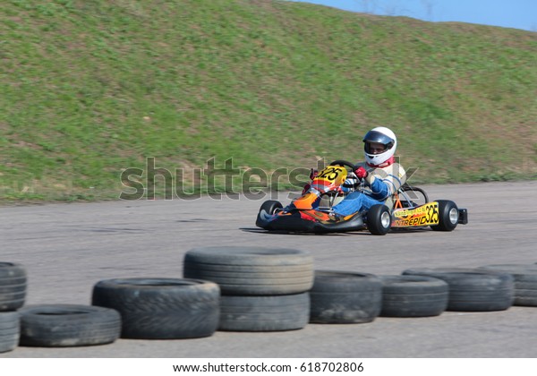 ODESSA, UKRAINE - April 2, 2017: karting
championship. Kart drivers in helmet, racing suit participate in
karting race. Carting show. Children, teenagers and adult kart
racing drivers.