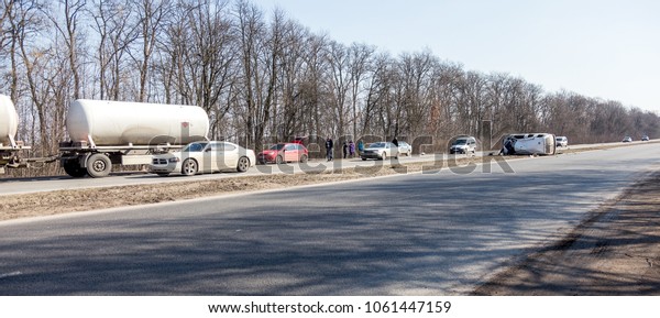 ODESSA, UKRAINE - April 20, 2018: A severe\
dramatic catastrophe on the highway. The common crashed car is\
damaged in the event of a rollover accident. Car crash - concept of\
insurance