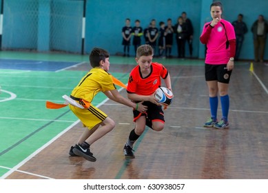 ODESSA, UKRAINE - April 29, 2017: Young children play rugby during final games of   city school in a closed hall. Children's sports. Kids plays rugby 5. Struggle for victory of children in rugby game