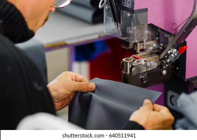 Odessa, Ukraine - APRIL 5, 2017: Close-Up Worker At Garment Factory Uses Lazar Equipment   