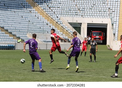 ODESSA, UKRAINE - Aug 24, 2021: Football. Traditional Cup Of Ukraine Among ATO Veterans. Veterans Play Football On Green Lawn Of  Stadium. Game Moment Of Football Fight For Cup. Vivid Emotions Of Game